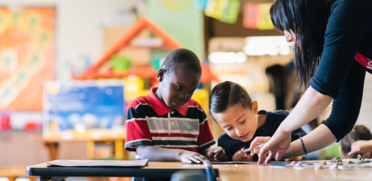 Teacher helping student write